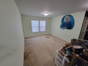 The new/old upstairs loft studio space with its walls repainted with a lighter shade of green. The carpet even after being cleaned is almost a lost cause but that's OK for studio use. The floors will be draped with wall to wall canvas drop clothes. Photo taken November 2023